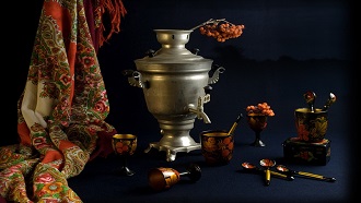 Dark table with silver Russian Samovar sitting on it