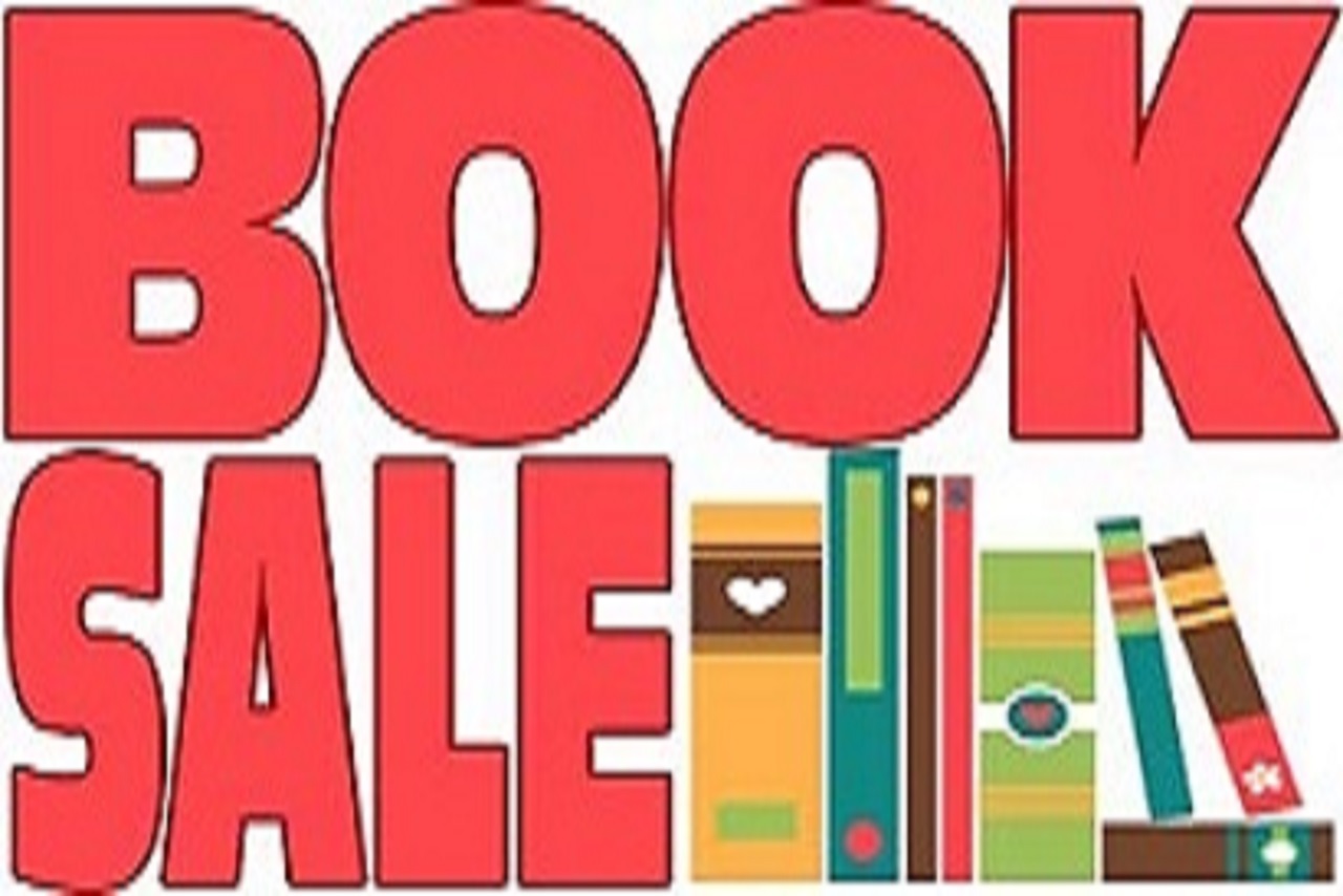 book sale in bold, red letters next to a shelf of books