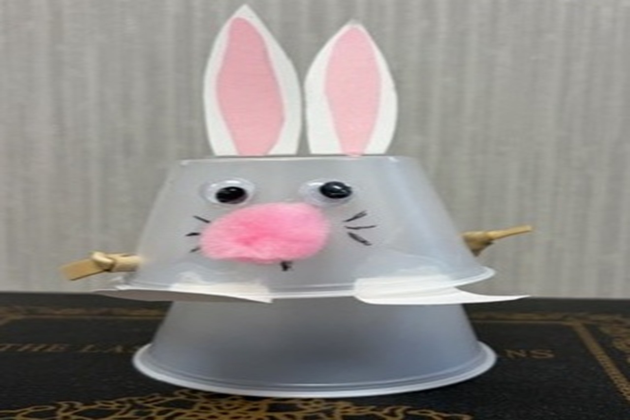 A plastic cup decorated as a bunny
