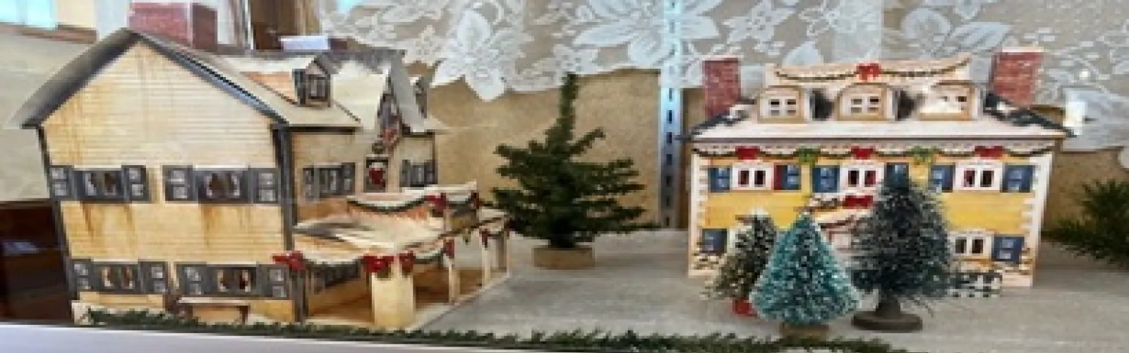 New England hotel and house made of paper set in a winter scene
