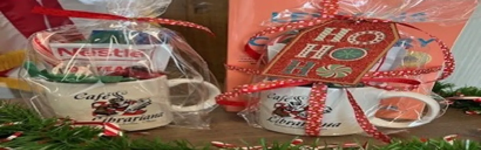 mugs filled with hot cocoa pack, candy cane and mint packaged in clear cellophane tied with Christmas ribbon